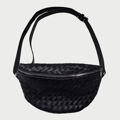 A Woven Crossbody Bag by Mauritius, made from vegetable-tanned cow leather in black, showcasing a woven design with an adjustable strap and zipper closure.