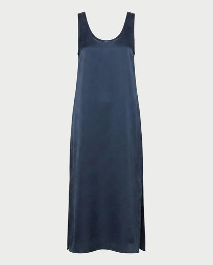 The Saint Art James Maxi Dress by Saint Art NY is a navy blue, sleeveless slip dress with a scoop neckline and side slits, crafted in shiny satin-look charmeuse—perfect for elegant events. Shown on a plain white background.