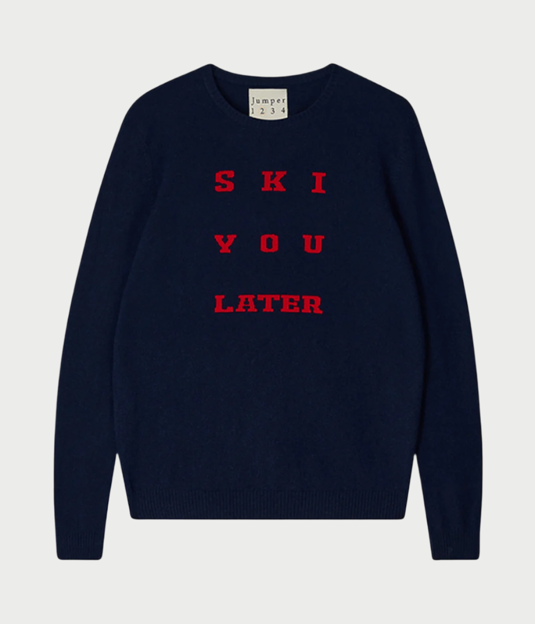 A navy blue cashmere sweater from JUMPER, titled "Ski You Later Crew," features red text reading "SKI YOU LATER" on the front. This crewneck sweater has long sleeves, offering cozy comfort.