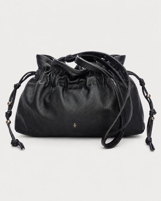 The Henry Beguelin Floriana Clutch is a handcrafted luxury handbag by Henry Beguelin, showcasing a black leather drawstring design with knotted side details, gold bead accents, and a small gold star logo on the front. Expertly made from premium Italian leather, the clutch is photographed against a plain light background.