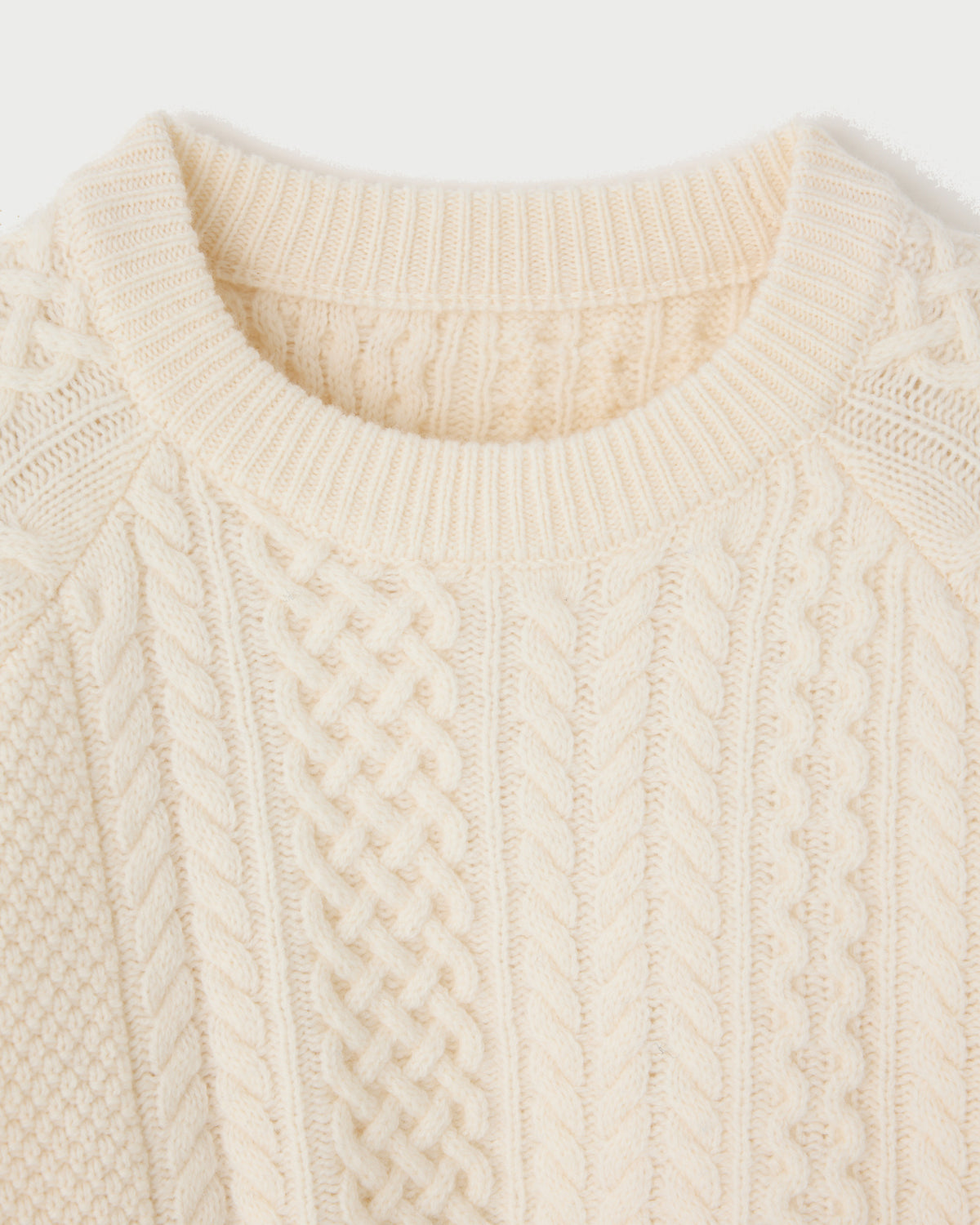 Cream-colored Moussy Panel Cable Pullover featuring vertical panels and rib-knit trim at the neckline.