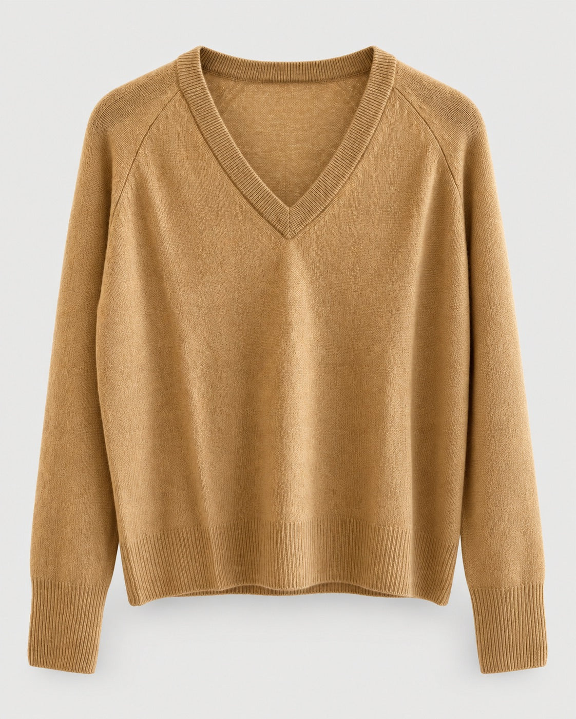 The One Grey Day Sloane Cashmere V-Neck is a camel-colored, long-sleeve sweater featuring ribbed cuffs and hem, crafted in a relaxed fit for effortless elegance and shown against a plain light background.