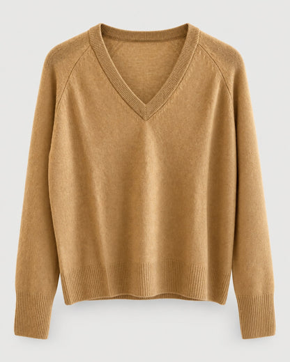 The One Grey Day Sloane Cashmere V-Neck is a camel-colored, long-sleeve sweater featuring ribbed cuffs and hem, crafted in a relaxed fit for effortless elegance and shown against a plain light background.