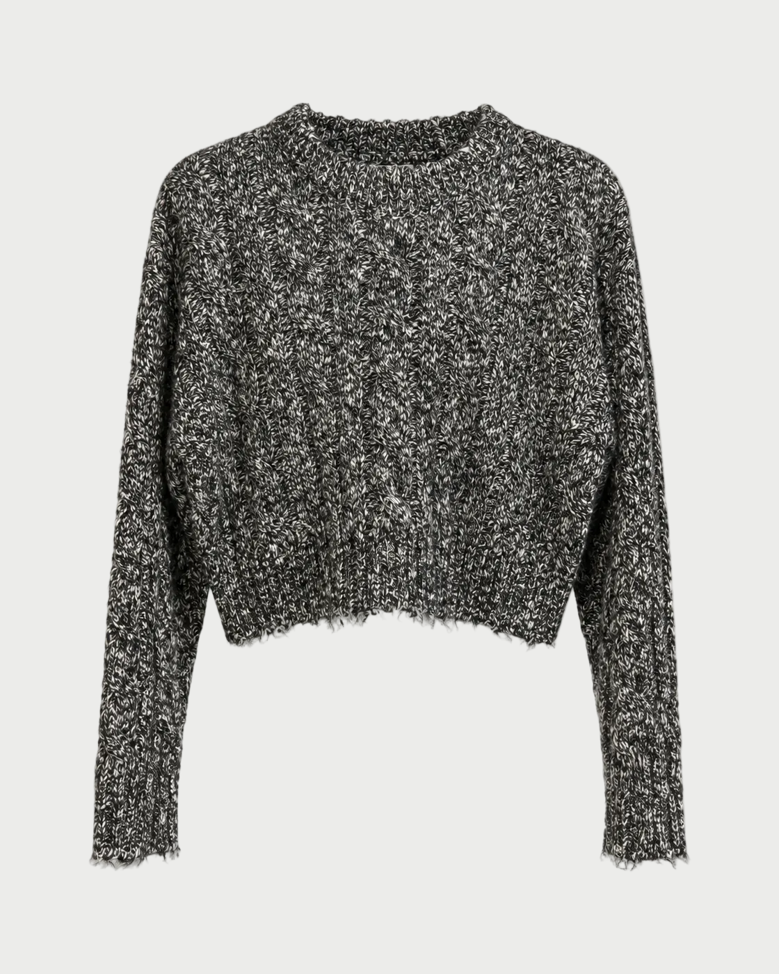 A cropped, long-sleeve knit sweater with a marled black and white texture, displayed on a clean white background.