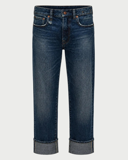 A pair of dark blue denim jeans with a straight-leg fit, featuring rolled cuffs and classic front pockets, shown against a light gray background.