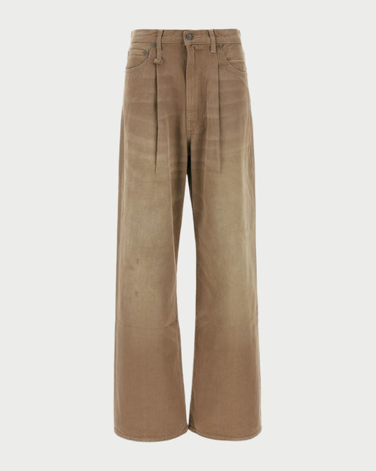 The Damon Pleated Jeans in Sawdust by R13 are wide-leg, high-waisted khaki denim pants with front pleats, side and back pockets, button-zipper closure, a slightly faded finish, and an oversized slouchy fit for relaxed comfort.