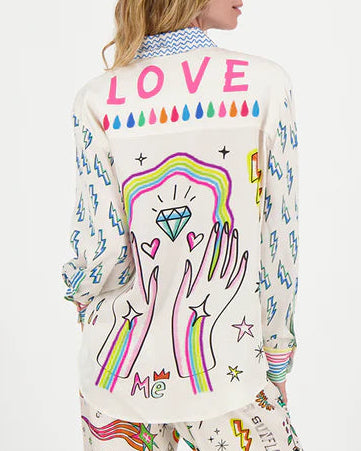 Person wearing a shirt with colorful designs on a white background