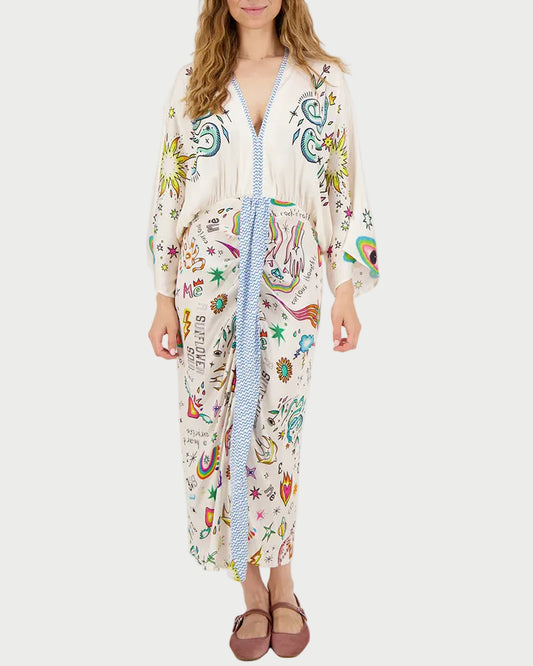 Woman wearing a colorful patterned dress on a white background