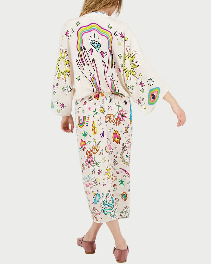 Woman wearing a colorful kimono dress with various designs on a white background