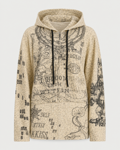 The ME369 Rumi Zip Hoodie by ME369 is a beige knit zip-up featuring a subtle dotted pattern and black, sketch-like graphics with abstract designs, text, and nature-inspired elements like plants and animals. Reminiscent of the brand’s Rumi Noir collection, this hoodie brings an artistic twist to casual wear.