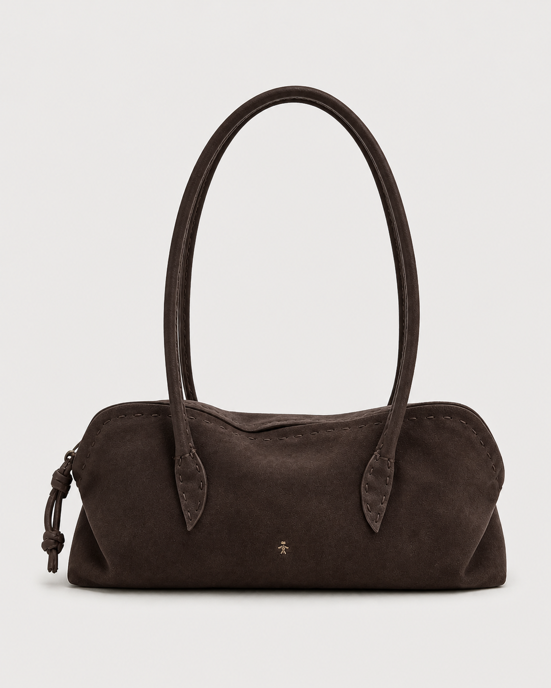 The Henry Beguelin Suede Bolla Bassa Bag features dark brown suede, two rounded top handles, subtle stitching that highlights Italian craftsmanship, a small gold emblem at the center, and a distinctive knotted accent on one side—an understated accessory embodying quiet luxury from Henry Beguelin, presented against a plain white background.