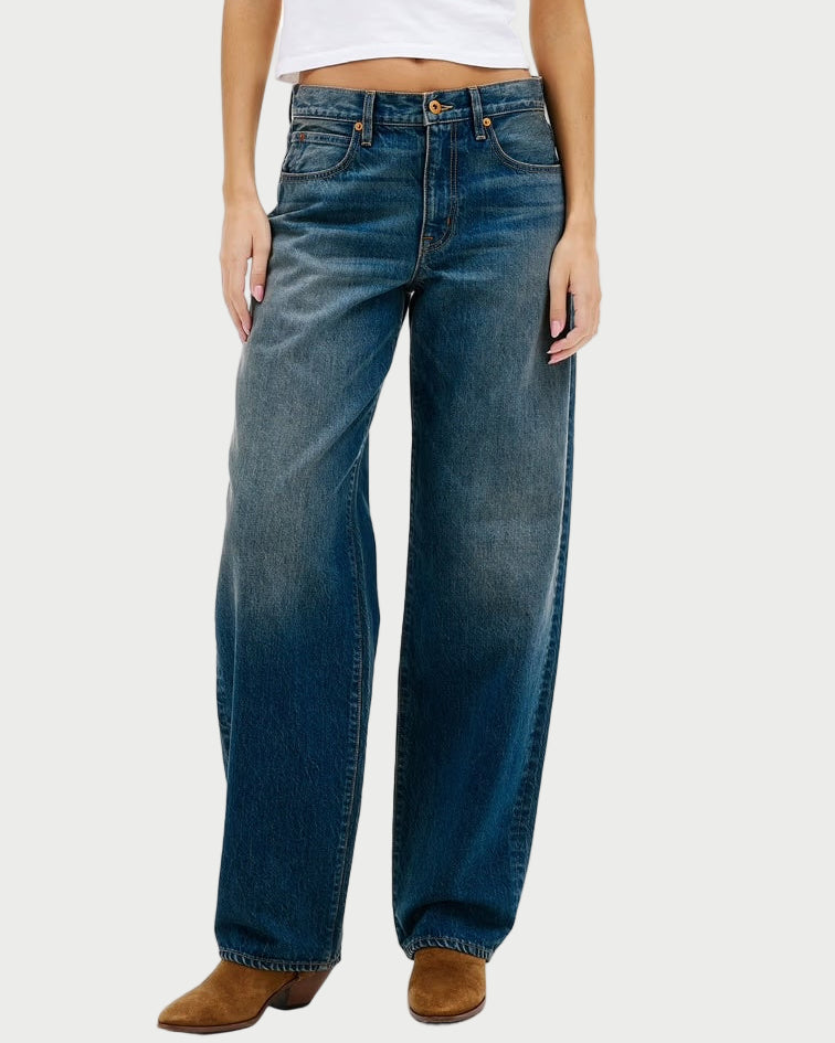 Woman wearing blue jeans and a white t-shirt on a white background