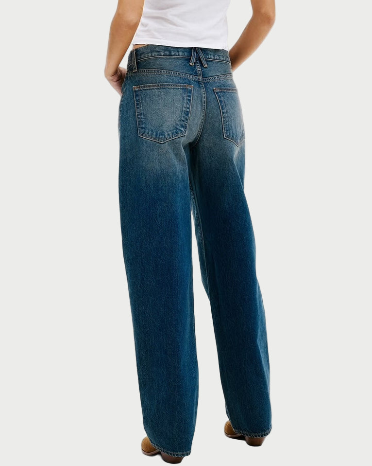 Person wearing blue jeans and a white shirt on a white background