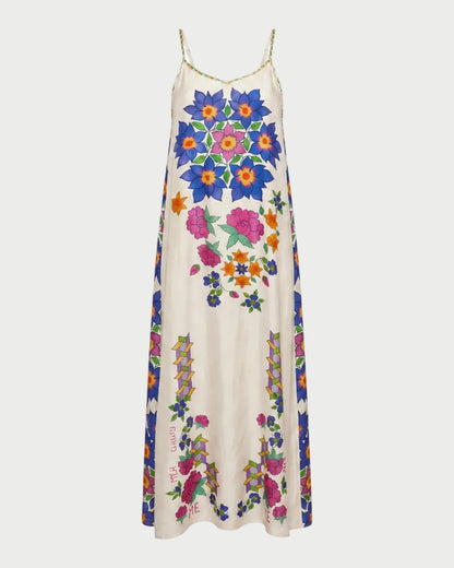 The ME369 Olivia Camisole Dress Markers is a long, sleeveless white dress with thin straps, made from 100% viscose and adorned with bold, colorful hand-drawn floral designs in blue, pink, orange, and green.
