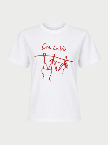 The Sunny Somewhere Sea La Vie Tee by Sunny Somewhere features red "Ça La Vie" text above a bikini line drawing on a white, lightweight crew neck tee with short sleeves and a relaxed fit—perfect for laid-back summer days.