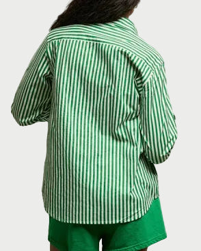 A person with long dark hair, seen from behind, wears the Perfectwhitetee Gisele Button Down by perfectwhitetee—a green and white vertically striped cotton blend shirt—paired with matching green shorts against a plain light background.