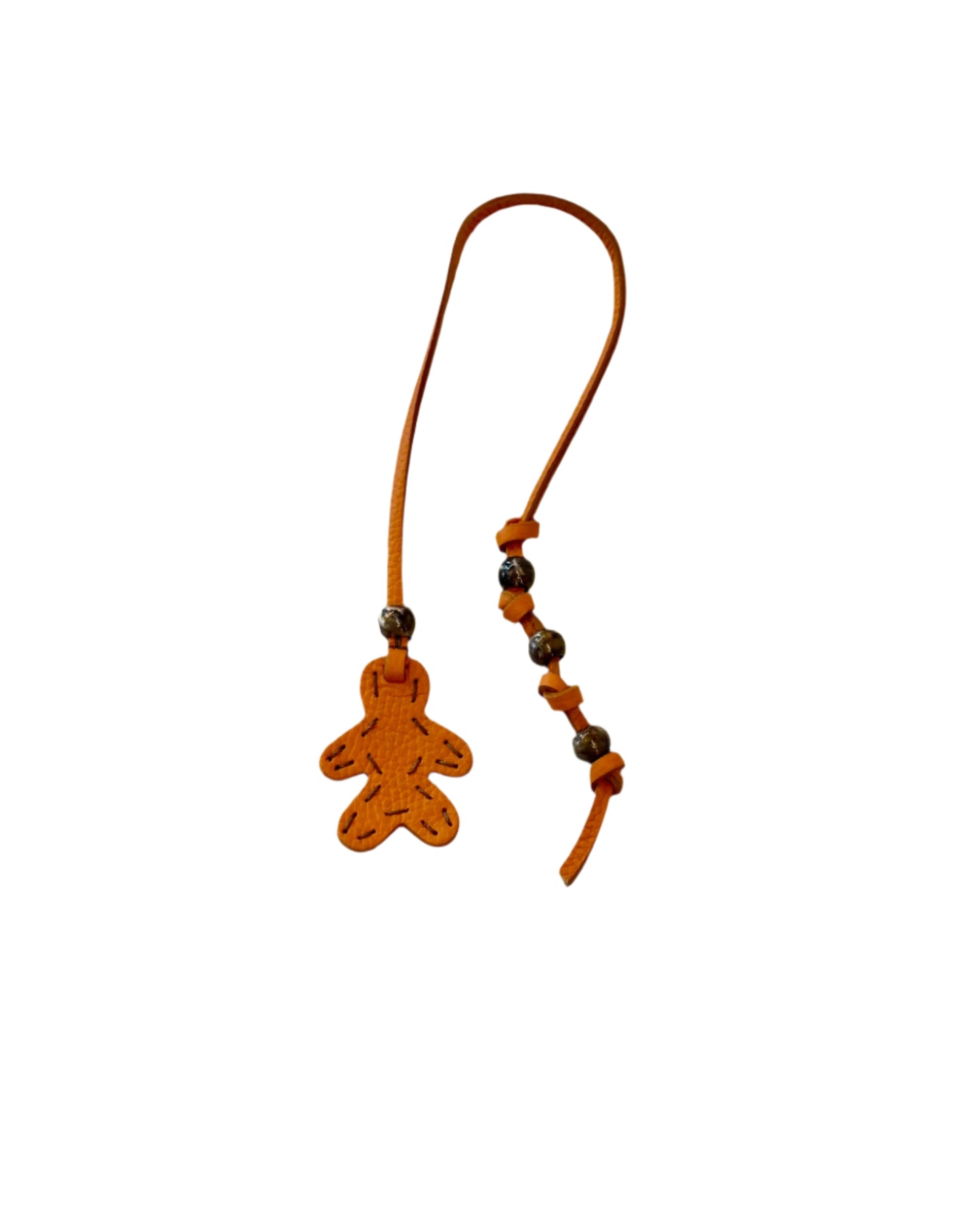 The Henry Beguelin Little Men Bag Charms feature a brown Italian leather strap with a gingerbread person-shaped charm and small round beads, shown on a white background.