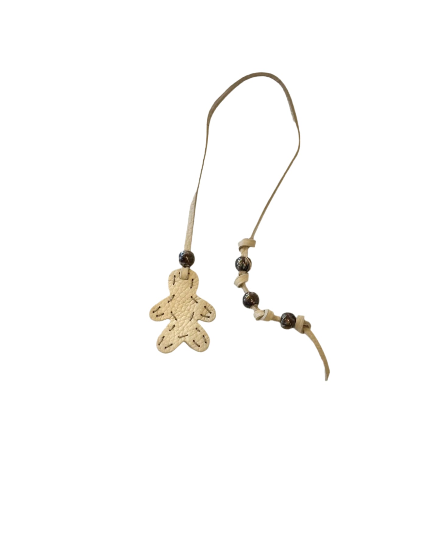 The Henry Beguelin Little Men Bag Charms feature a gingerbread person-shaped pendant on an Italian leather cord with several round dark beads, shown against a white background.