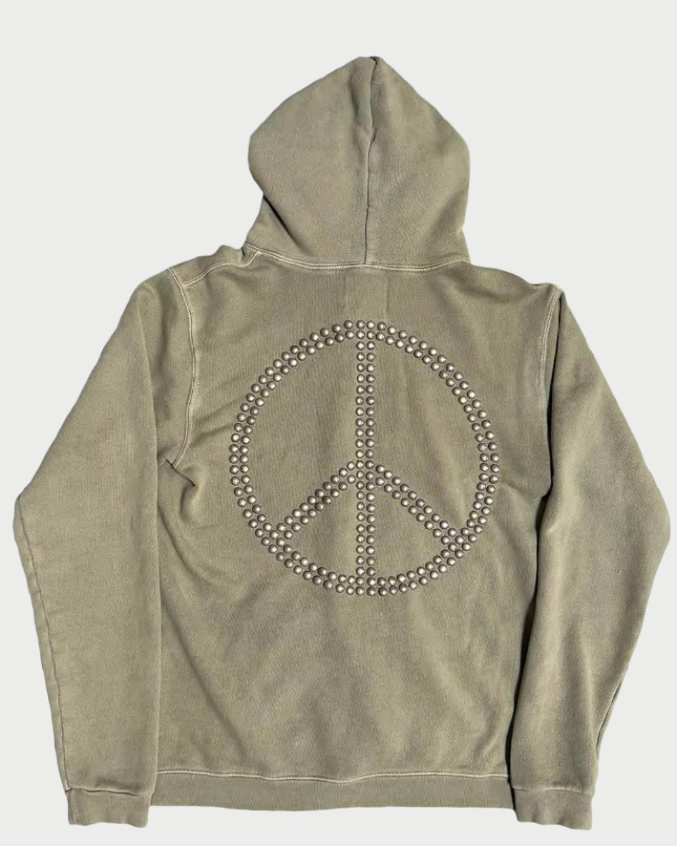 The Madeworn Flower Power Hoodie by Madeworn features a khaki hue and a large peace symbol on the back, embellished with metallic studs for a vintage athleisure look.