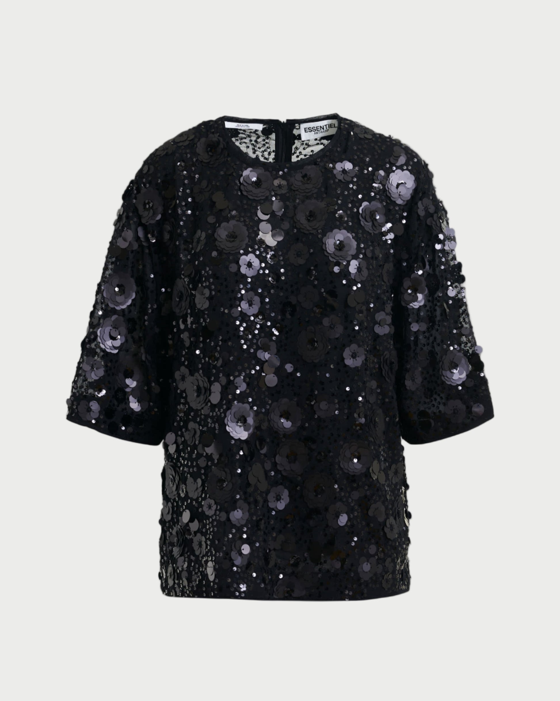 Black sequin dress on a light gray background