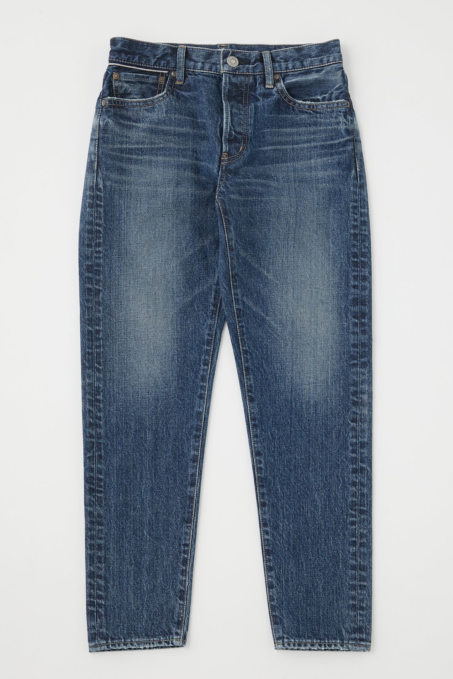 Laid flat on a white background, Moussy's Ivanhoe Tapered Mid Rise Jeans boast premium Japanese denim with a classic five-pocket design, button closure, and visible fading on the thighs and knees for an effortlessly worn look.