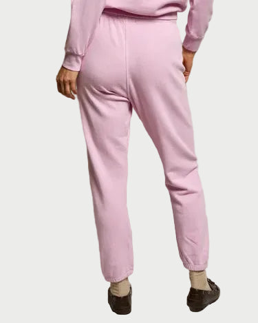 Person wearing a pink outfit against a neutral background