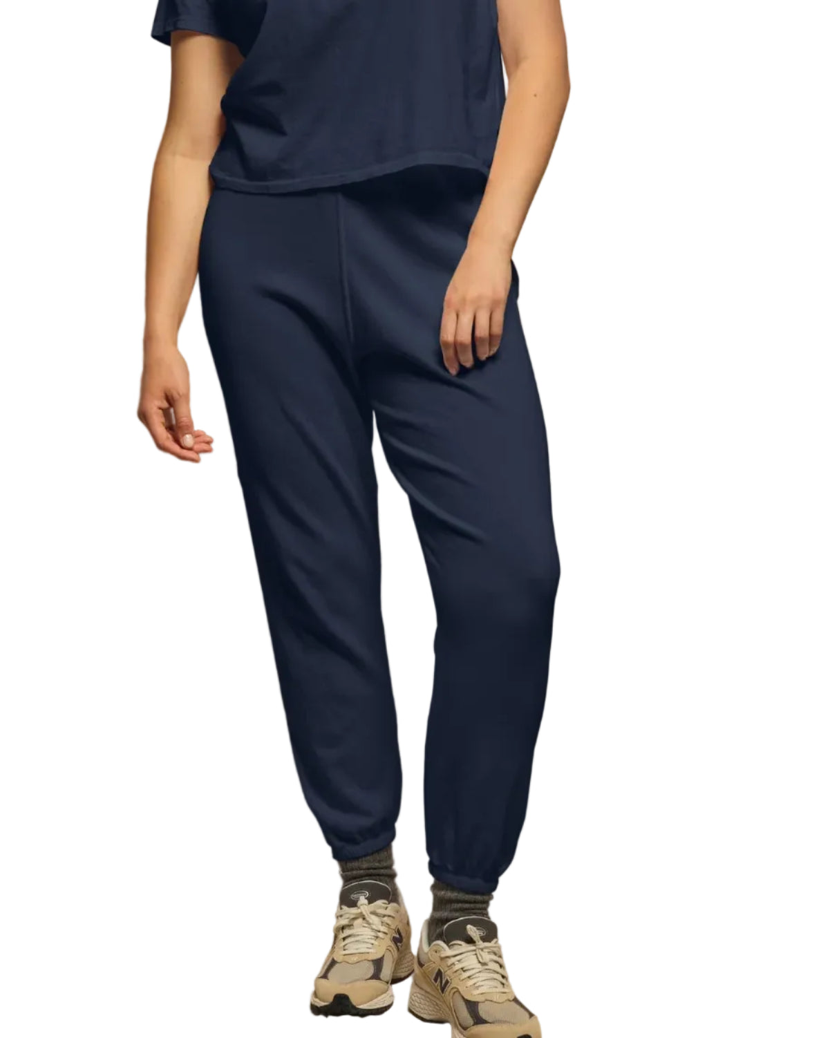 A person wears perfectwhitetee’s Perfect White Tee Johnny Sweatpant in navy with a matching navy tee, gray socks, and beige sneakers, standing against a white background for the ultimate comfort look.