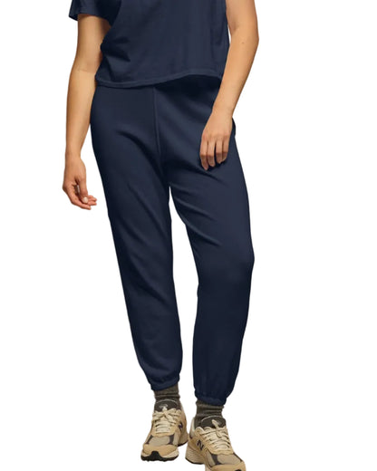 A person wears perfectwhitetee’s Perfect White Tee Johnny Sweatpant in navy with a matching navy tee, gray socks, and beige sneakers, standing against a white background for the ultimate comfort look.