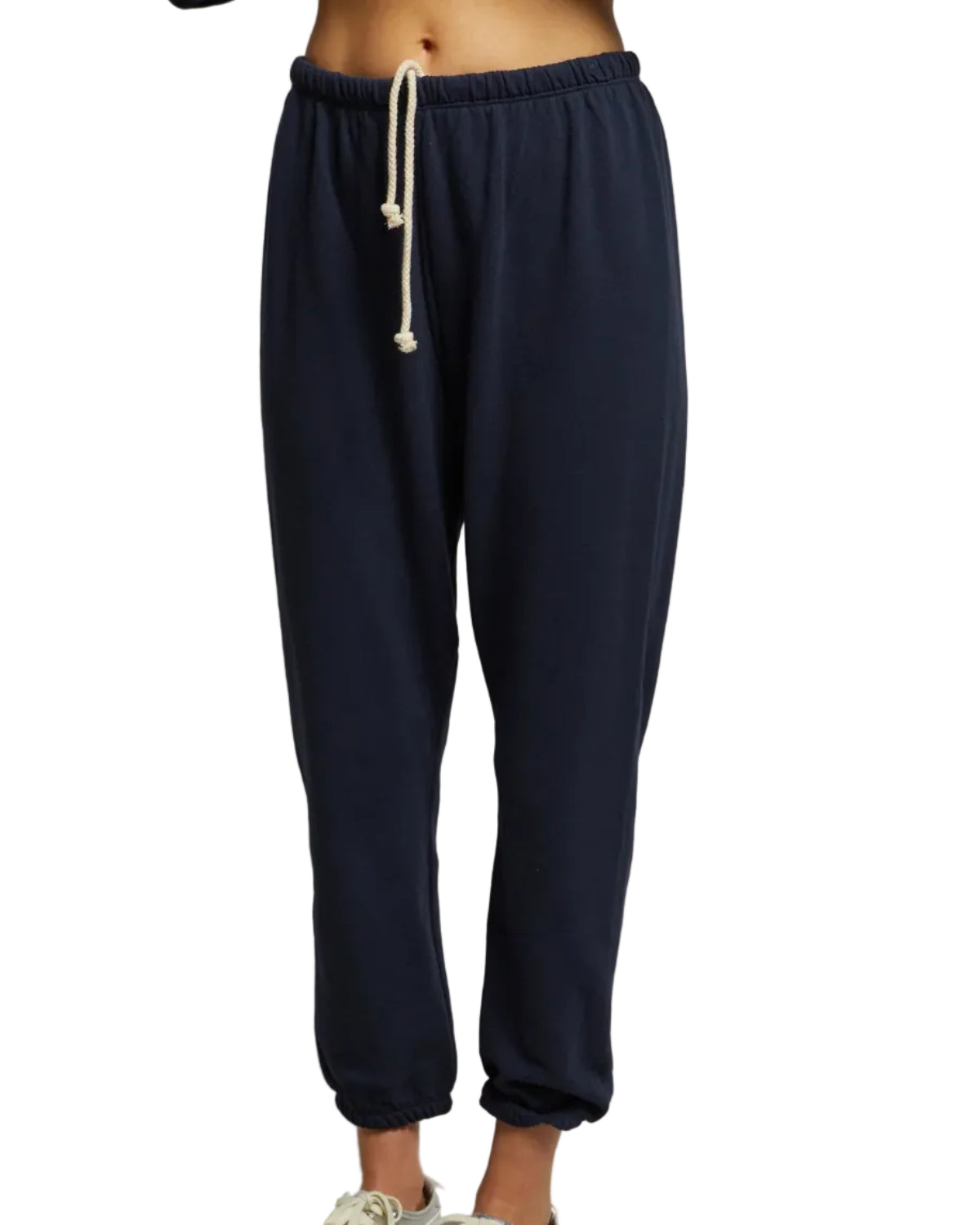 A person models the perfectwhitetee Perfect White Tee Johnny Sweatpant in navy—dark blue french terry cotton joggers with an elastic waistband and white drawstring, shown from the waist down against a white background.