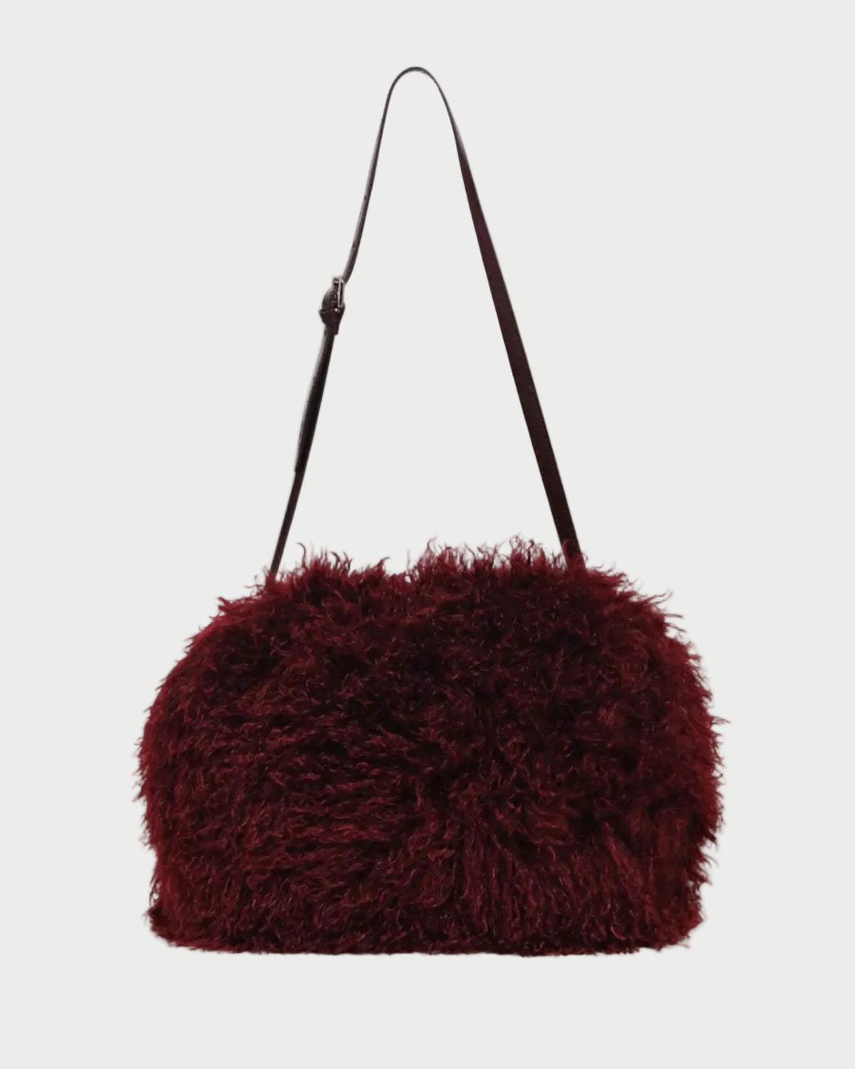 A dark burgundy shaggy faux-fur shoulder bag with a slim black strap, shown against a plain light gray background.