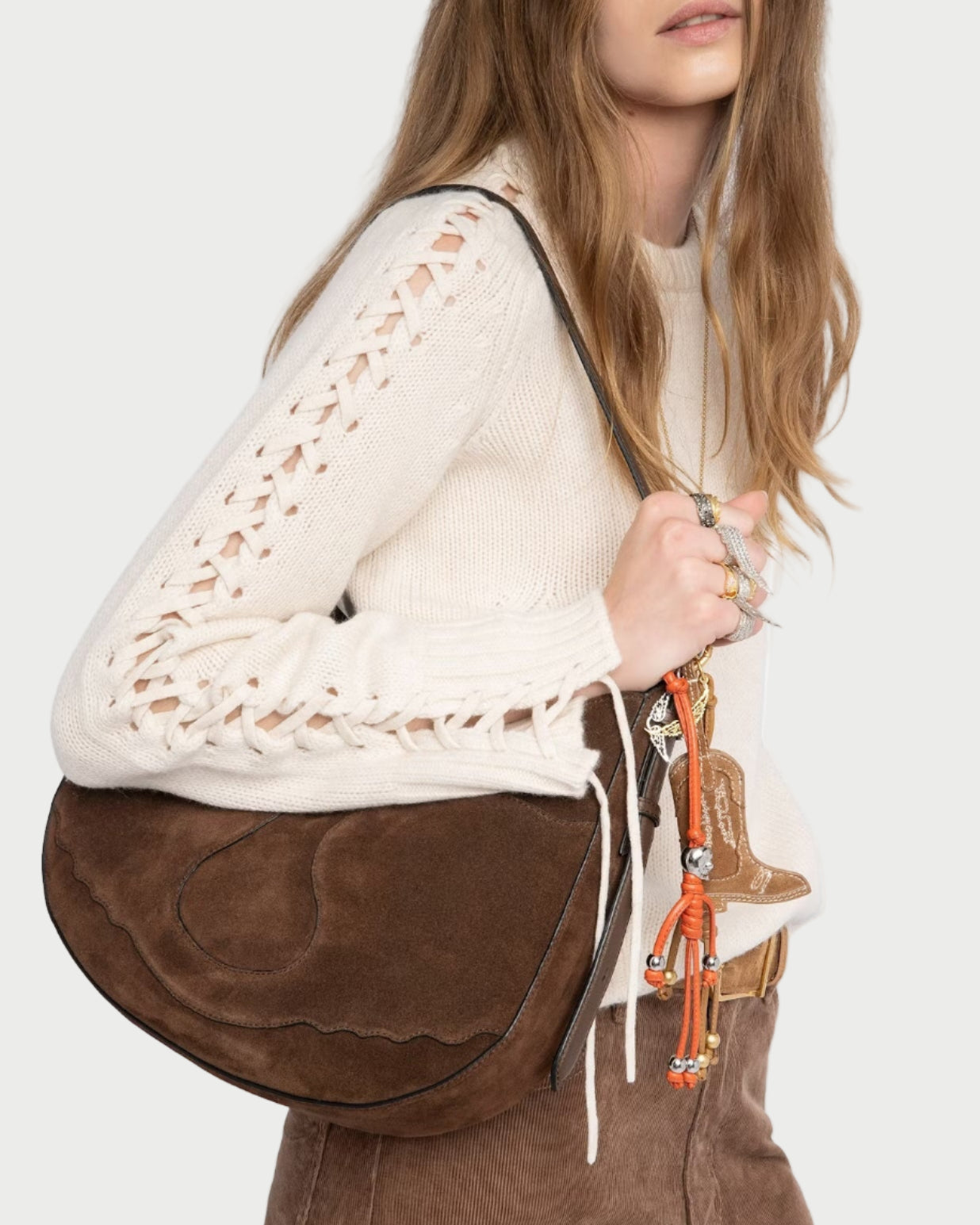 woman wearing an ivory laced sleeve sweater on a white background.