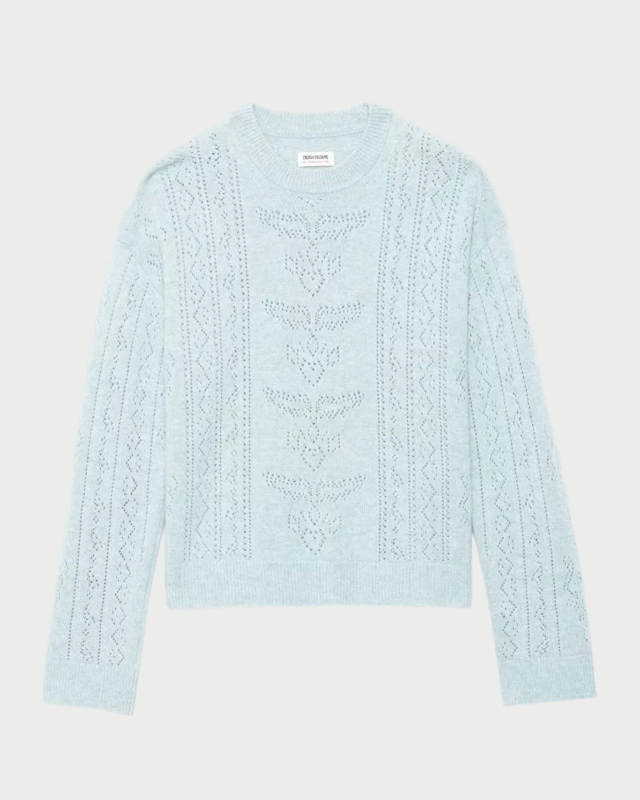 A light blue knit sweater with vertical cable and geometric patterns, laid flat against a light gray background.
