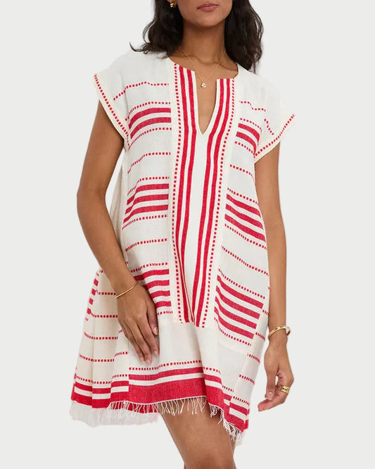 Woman wearing a white and red patterned dress on a white background