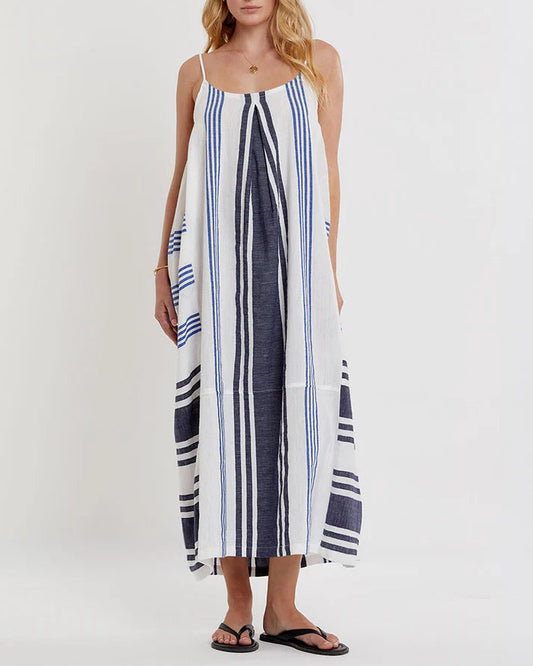 Woman wearing a long striped dress on a white background