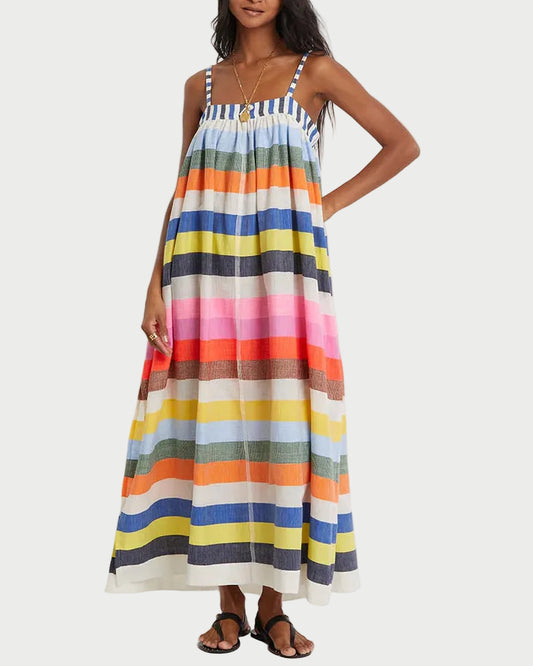 Woman wearing a colorful striped dress on a white background