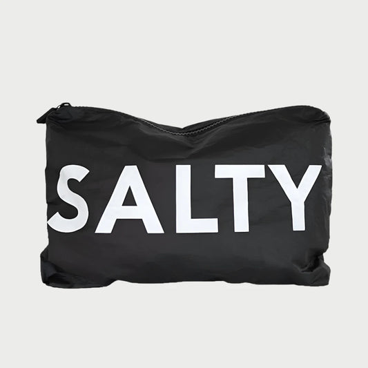 Introducing the LOCAL BEACH Printed Pouch - Salty: a black water-resistant zippered pouch made from 100% Tyvek, featuring the word "SALTY" prominently displayed in large white letters on the front, perfect for safeguarding your travel toiletries.