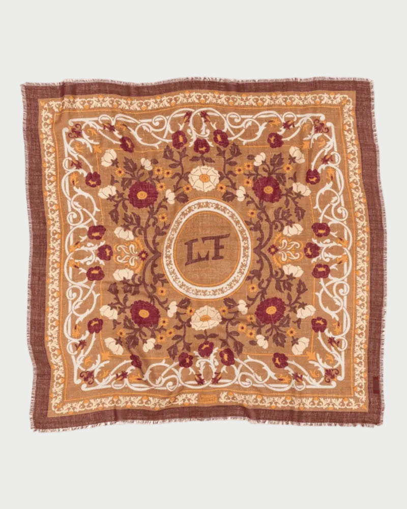 Decorative square mat with floral patterns and initials 'LF' on a white background