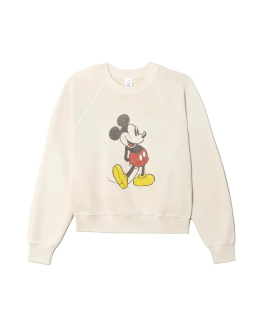 The RE/DONE Mickey Mouse Classic Crewneck Sweatshirt is cream-colored and features a vintage-inspired graphic of Mickey Mouse standing and smiling in his classic red shorts and yellow shoes.