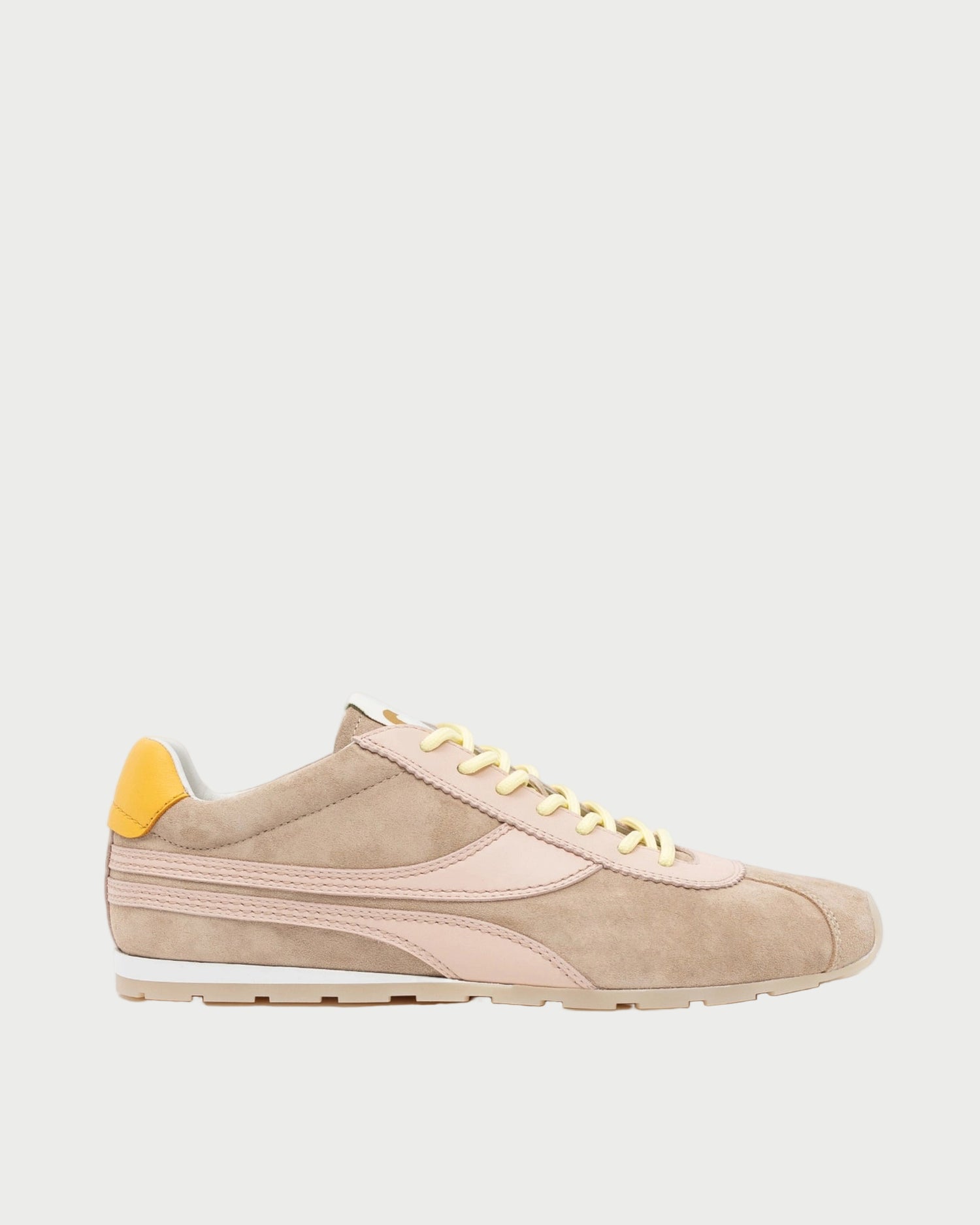 Beige sneaker with yellow accents on a white background