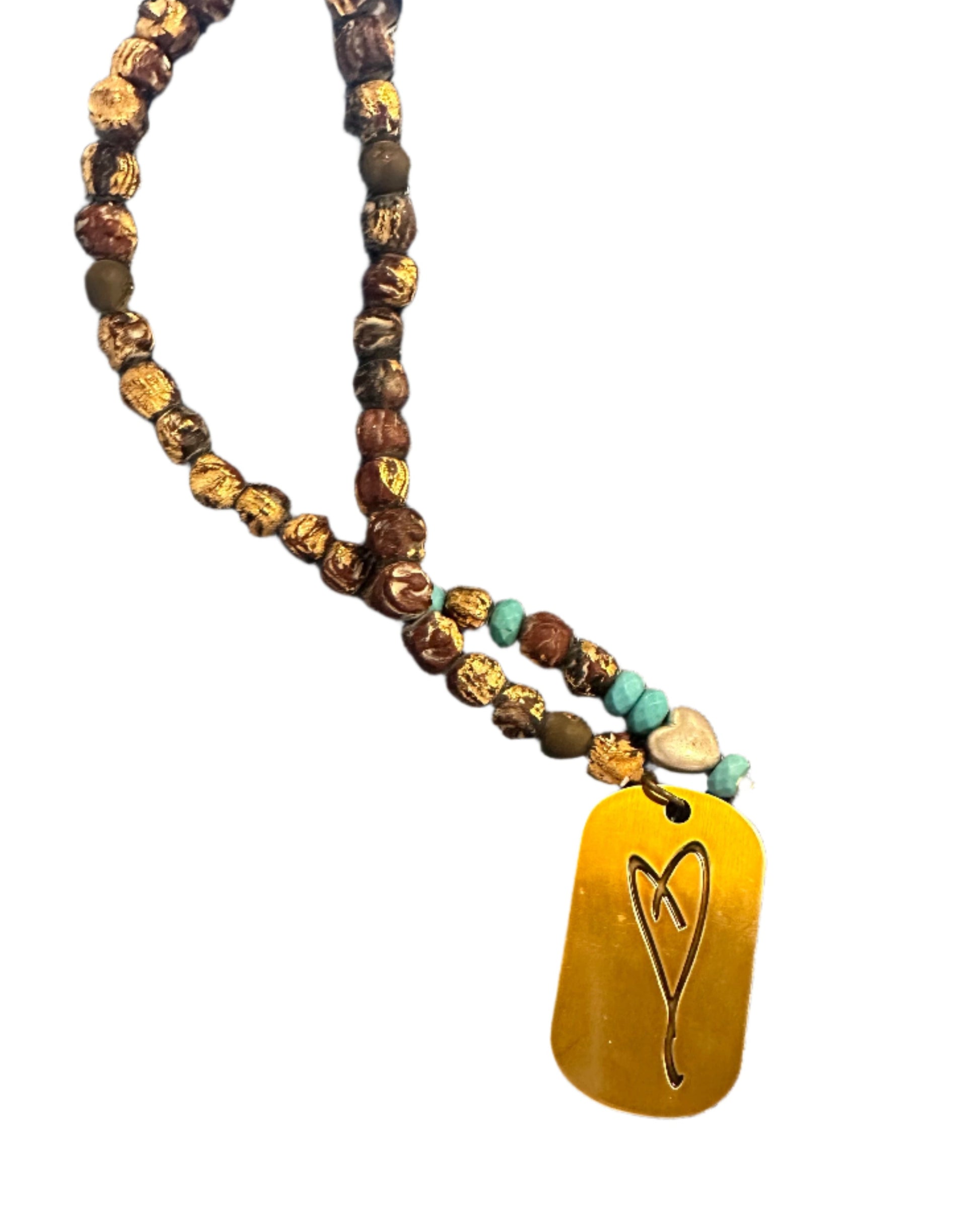 The Here's To Life Bag Charm by Simply Eartha is a must-have accessory featuring a blend of brown, antique gold, and turquoise beads with a gold pendant engraved with a heart design, showcased against a plain white background.