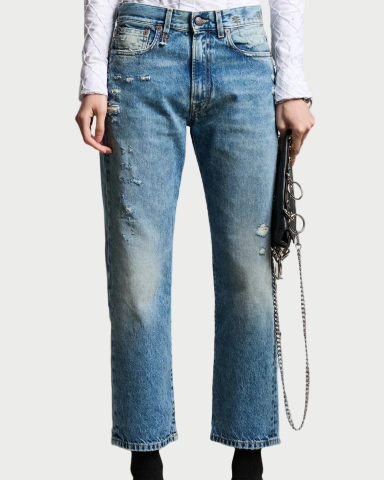 Blue jeans worn by a person on a white background
