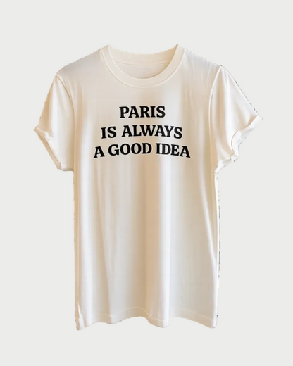 The Recycled Karma Paris Is Always A Good Idea Tee by RECYCLED KARMA features a white vintage-inspired design with rolled sleeves and bold black "PARIS IS ALWAYS A GOOD IDEA" text on the front. Made from 100% cotton, this tee offers timeless comfort and effortless style.