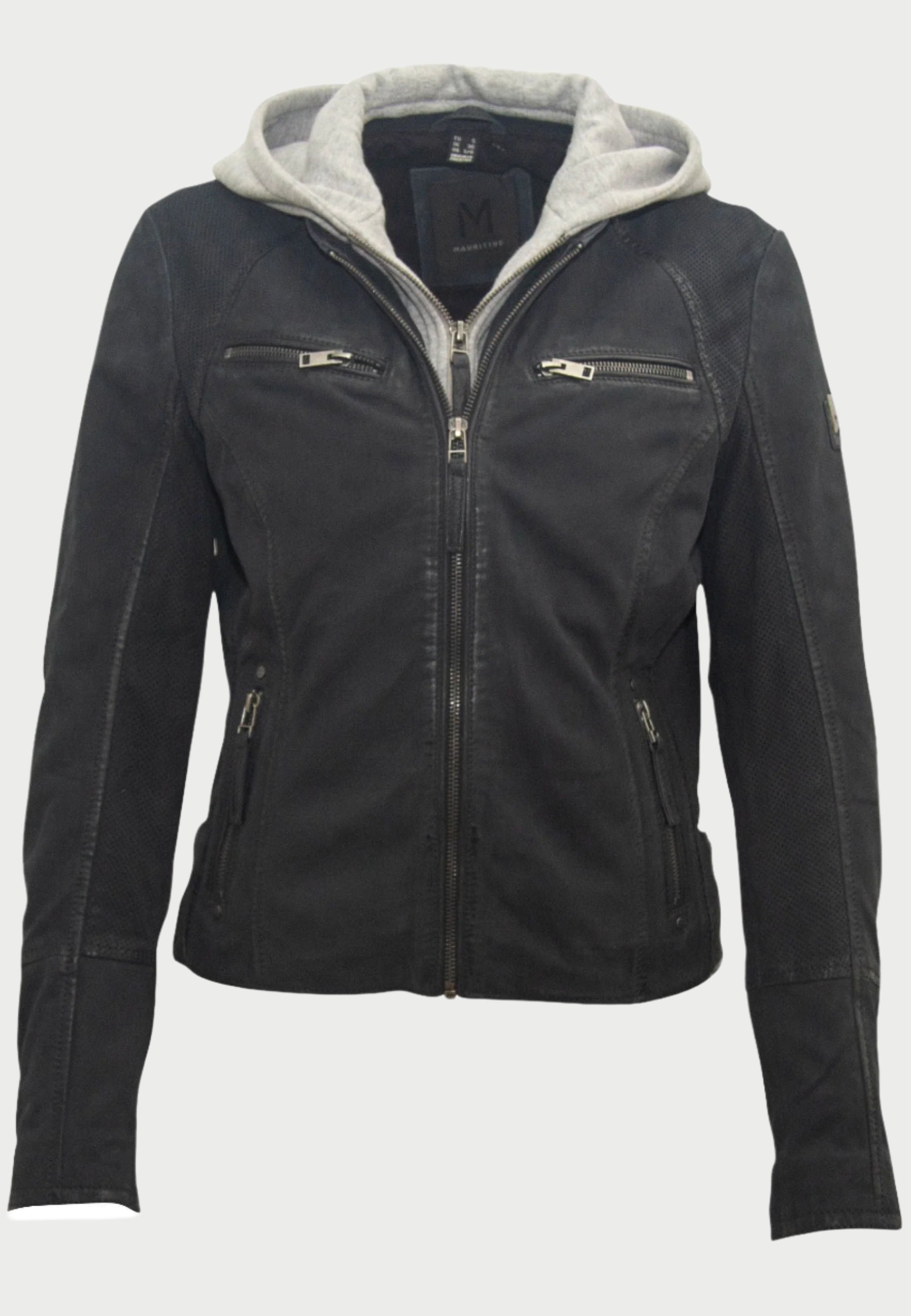 The Soft Nubuck Leather Jacket by Mauritius is a black nubuck leather moto jacket with a gray removable hoodie. It features zippers on the front, chest pockets, side pockets, and has a badge on the left sleeve.