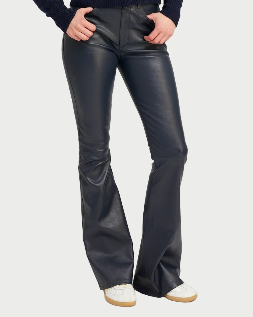 Midnight leather bell-bottom pants worn by a person on a white background