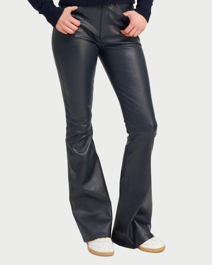 Midnight leather bell-bottom pants worn by a person on a white background