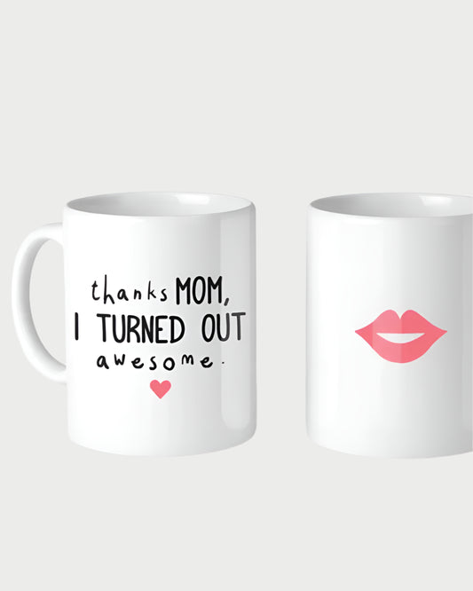 Two white ceramic mugs by 365 Printing Inc are shown. The 11oz "Thanks Mom, I Turned Out Awesome" mug features a pink heart, while the other displays pink lips. Both are made in the USA and set against a plain white background.