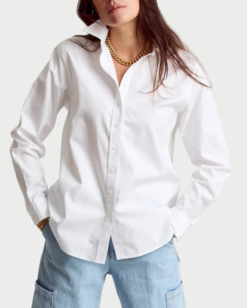 Woman wearing a white shirt and light blue jeans on a white background