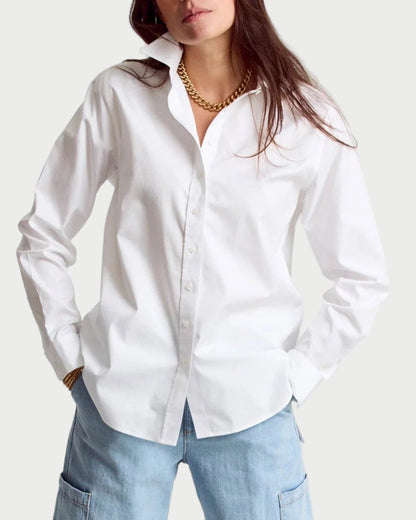 Woman wearing a white shirt and light blue jeans on a white background