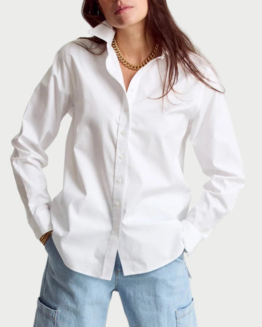 Woman wearing a white shirt and light blue jeans on a white background