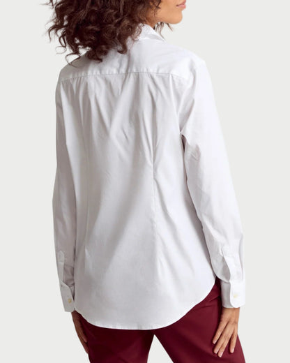 Person wearing a white shirt and red pants on a plain background